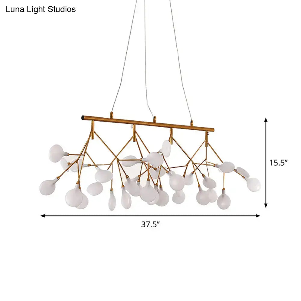 Gold-toned metal tree branch ceiling light with frosted glass globes for minimalist dining room decor by DecorBites™