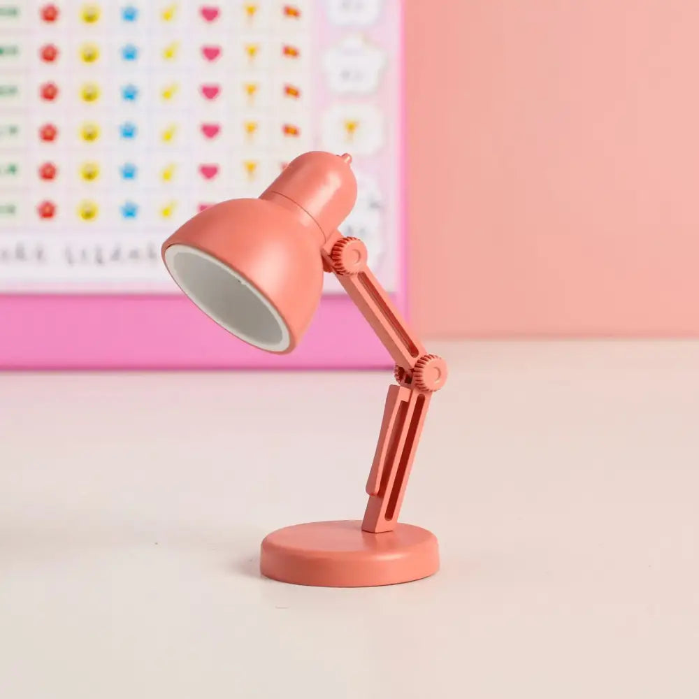 Coral-colored decorbites led mini desk lamp with adjustable arm foldable design and magnetic base for bedroom use