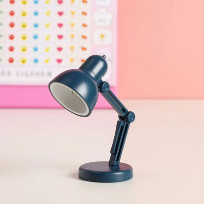 A navy blue decorbites led mini desk lamp with adjustable arm, matte metal body, and eye protection for study and bedroom