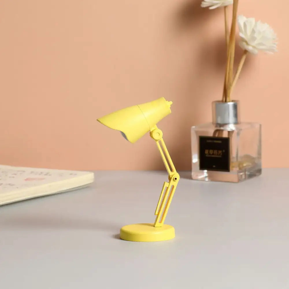 A bright yellow decorbites led mini desk lamp with flexible arm and magnetic base for bedroom night light use