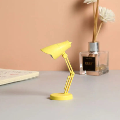 A bright yellow decorbites led mini desk lamp with flexible arm and magnetic base for bedroom night light use