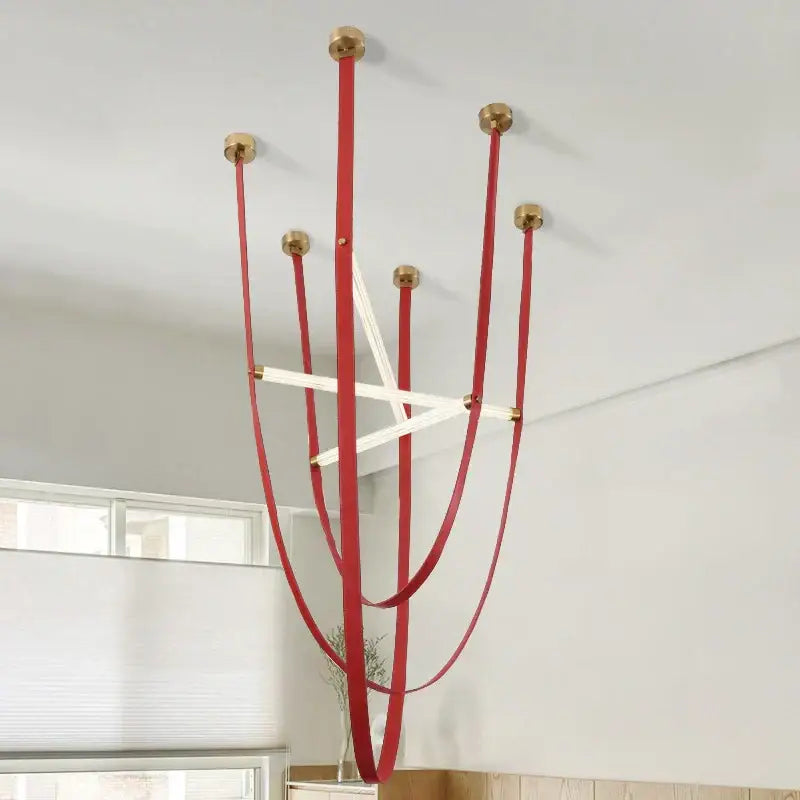 Red leather straps with brass fittings and white elements form a decorbites led minimalist pendant lamp chandelier