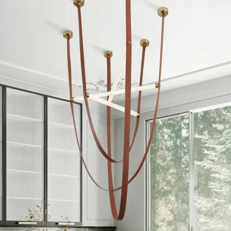 Decorbites led minimalist pendant lamp with slender brown leather straps brass fixtures and intersecting white light bars