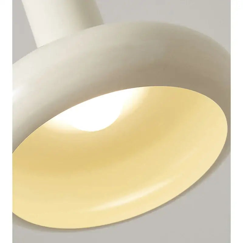 Cream-colored smooth-surfaced decorbites led minimalist nordic pendant light with warm yellow glow for living room use
