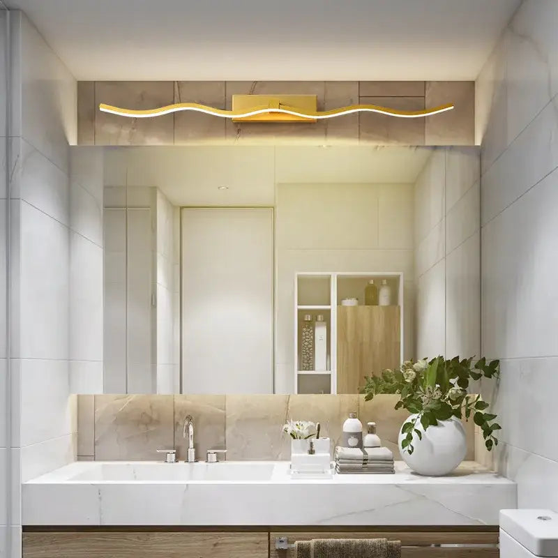 Gold-colored wavy led mirror bathroom wall light with sleek modern design by decorbites led mirror luminaires