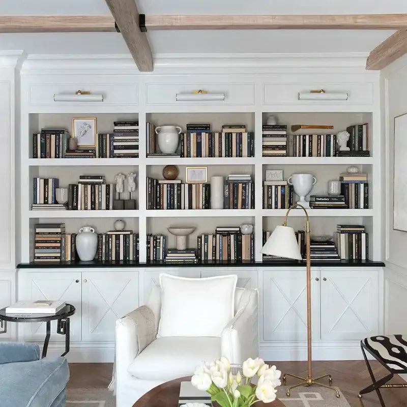 White upholstered armchair with plush cushion and textured throw displayed near decorbites led mirror cabinet with special light