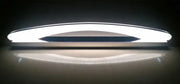 Modern white DecorBites LED mirror light fixture with sleek curved design and central dark accent strip for makeup bathrooms