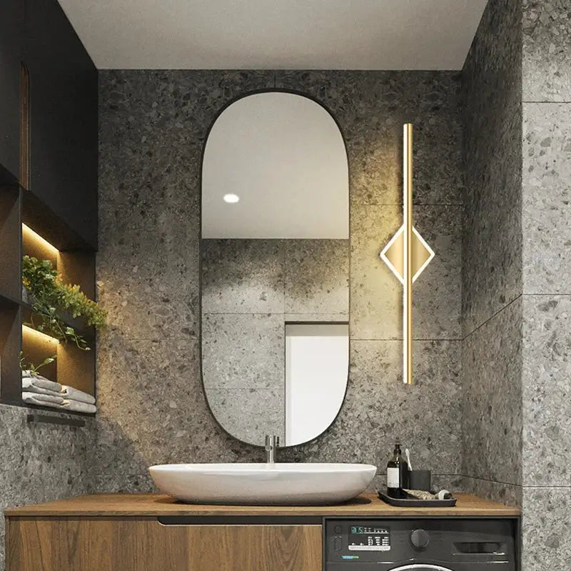 Modern oval decorbites led mirror wall lamp with sleek black frame and led mirror light above white vessel sink in bathroom