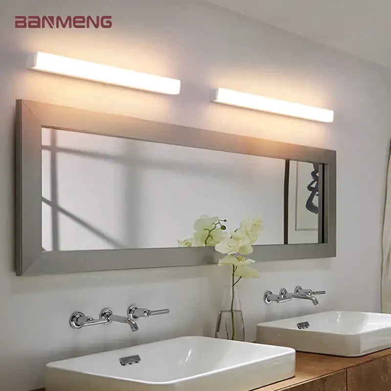 Two sleek modern warm white decorbites led mirror wall sconces mounted above a bathroom mirror for indoor lighting