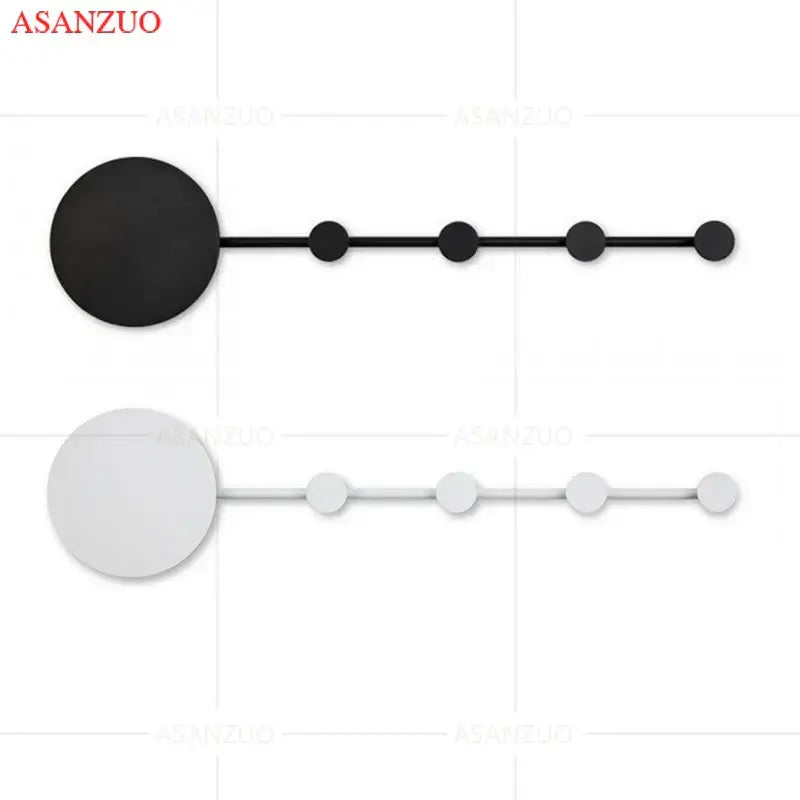 Minimalist black and white wall-mounted coat racks with circular design complement decorbites led moon wall lamp
