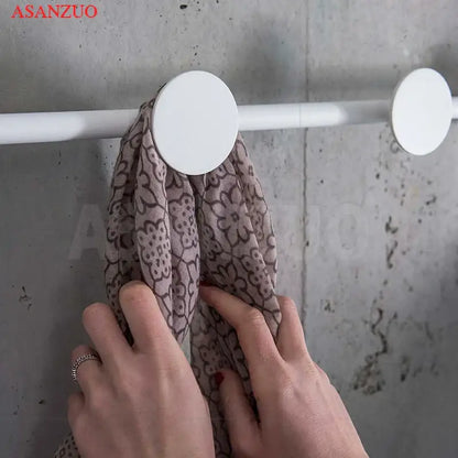 White circular hook holding a mauve scarf with brown floral patterns beside DecorBites led moon wall lamp