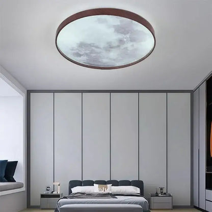 Circular decorbites led moon ceiling light with walnut wood frame and frosted glass panel showing a cloudy sky design