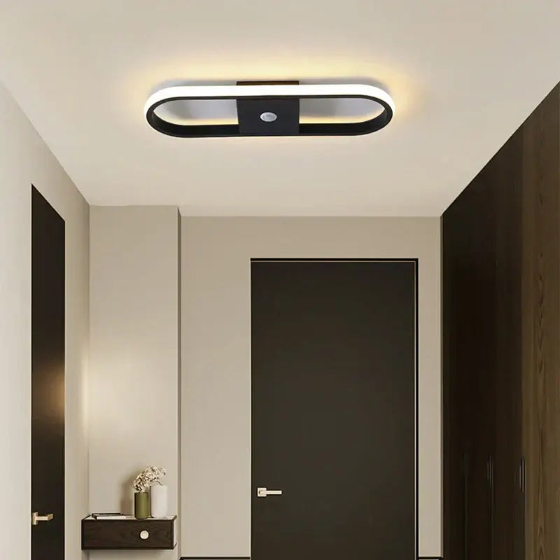Modern black and white oval decorbites led motion sensor ceiling light with sleek minimalist design for indoor use