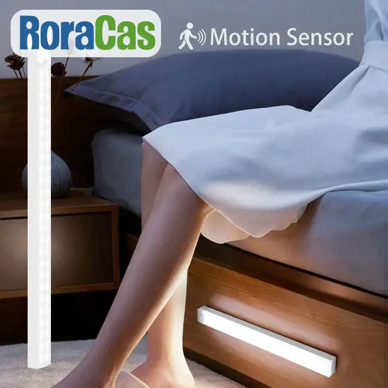 White DecorBites LED motion sensor light bar mounted on wooden drawer with USB rechargeable handheld lamp feature