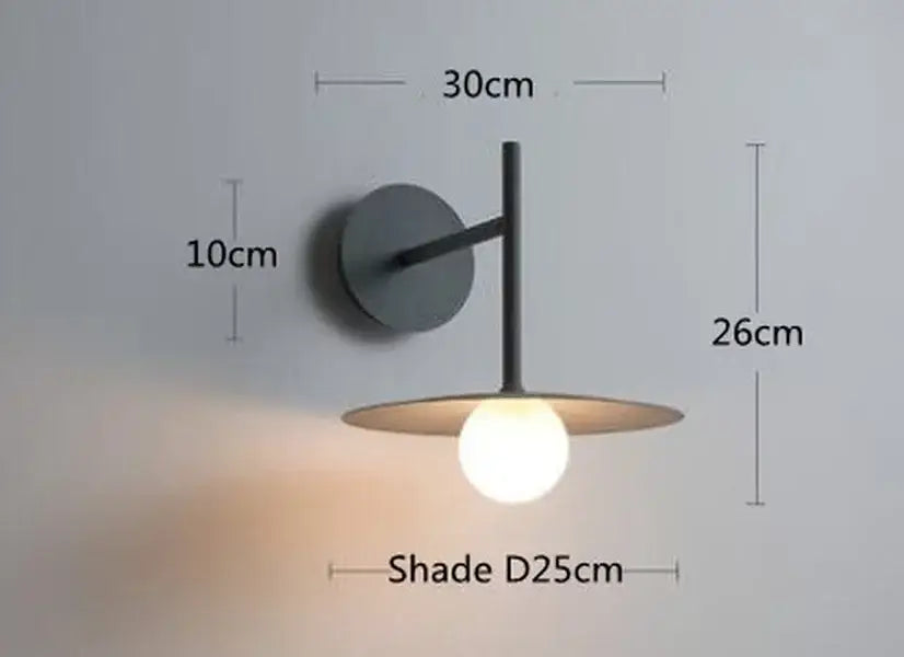 Modern black metal wall lamp with circular base and flat disc shade decorbites led movable arm for indoor use