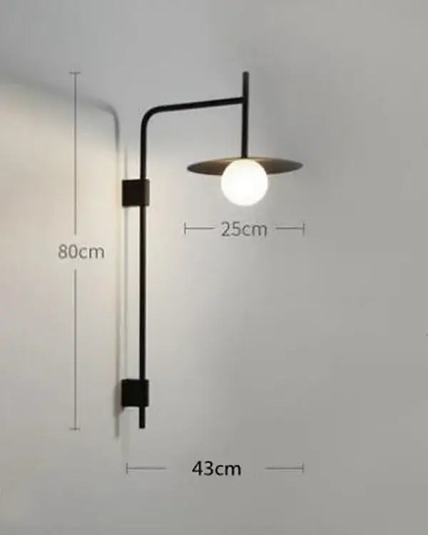 Black metal wall lamp with curved arm and frosted glass globe bulb decorbites led movable arm for indoor use