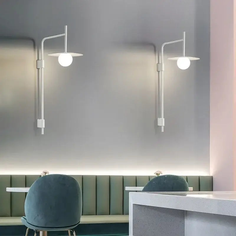 Two minimalist white decorbites led movable wall lamps with curved arms and frosted glass shades for indoor lighting