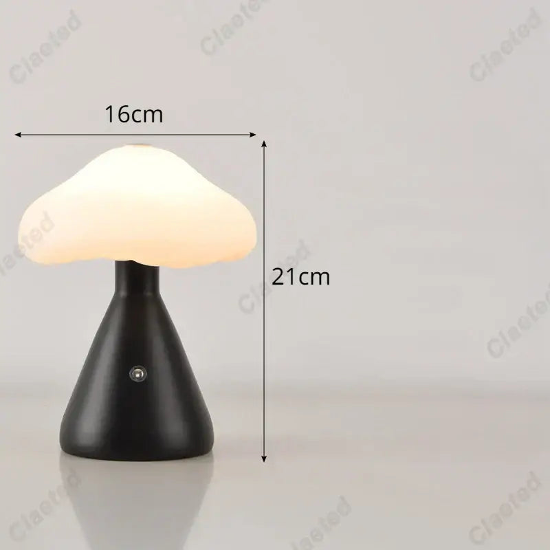 A sleek black decorbites led mushroom night light with a soft glowing white translucent cap for bedside use