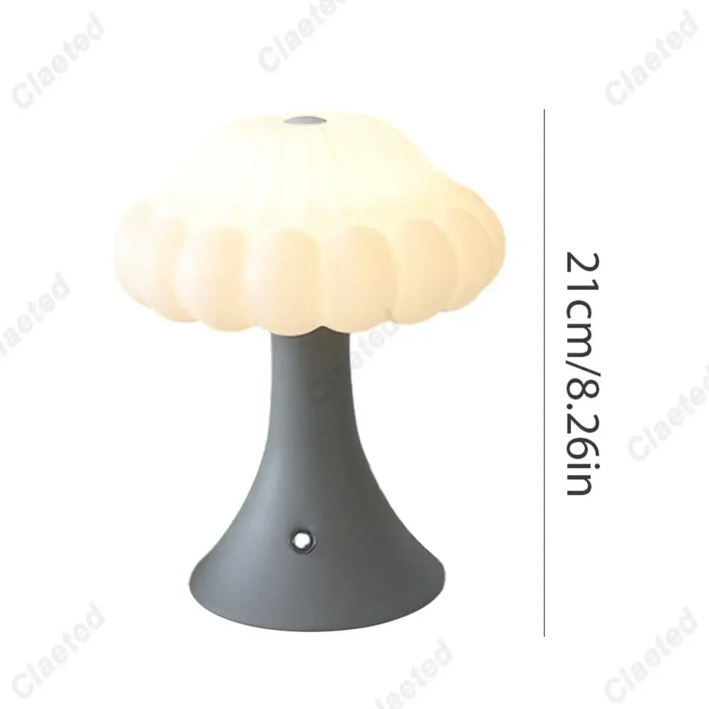 A cream-colored decorbites led mushroom night light with a matte gray base and touch switch for kid’s room decor