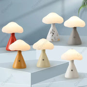 A collection of DecorBites led mushroom night light lamps in red plastic, wood-toned resin, gray ceramic, and cream marble