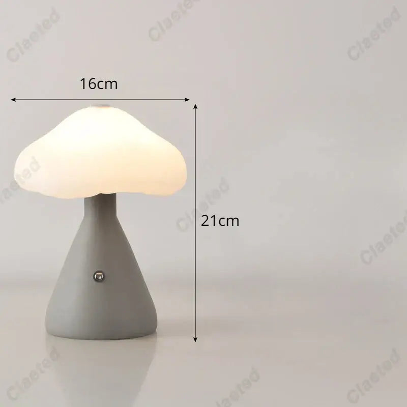 A soft glowing decorbites led mushroom night light with a matte gray base and translucent white cap for kid’s room decor