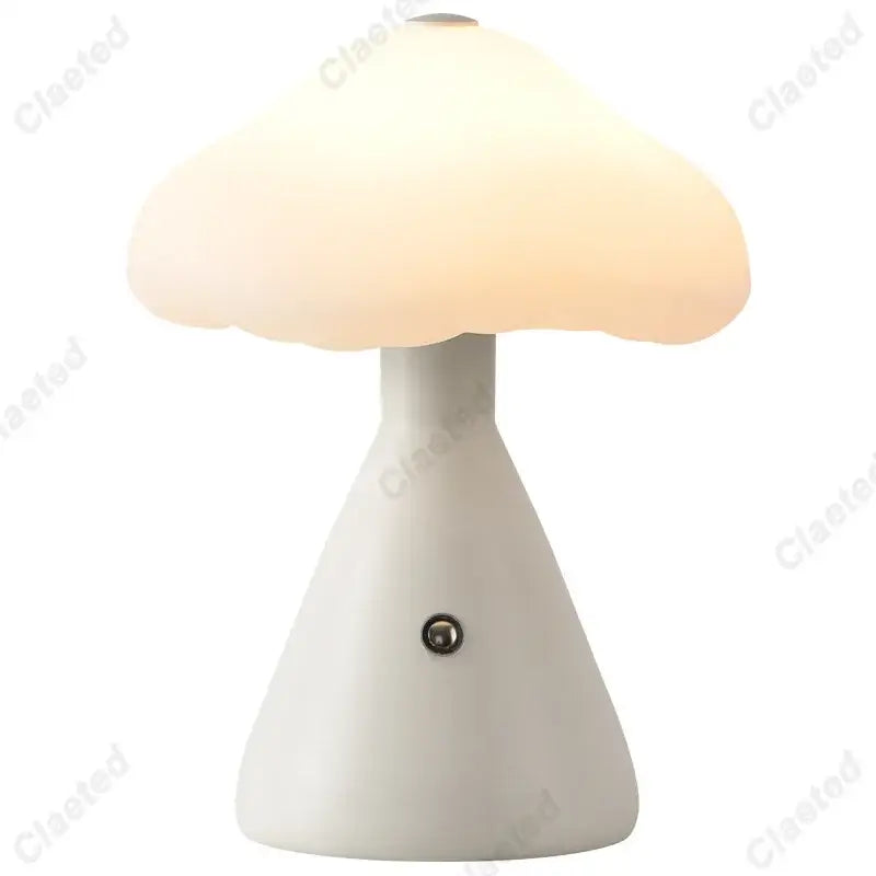 A decorbites led mushroom night light with a smooth white ceramic base and glowing off-white glass cap for kids room decor