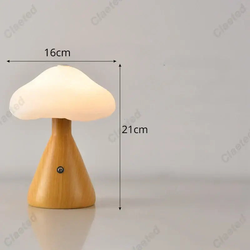 A warm glowing decorbites led mushroom night light with smooth wooden base and white translucent cap for kids room decor