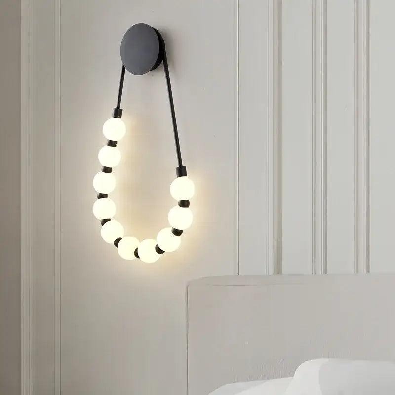 Modern black wall sconce with circular glowing white acrylic bulbs decorbites led necklace wall lights in gold black metal