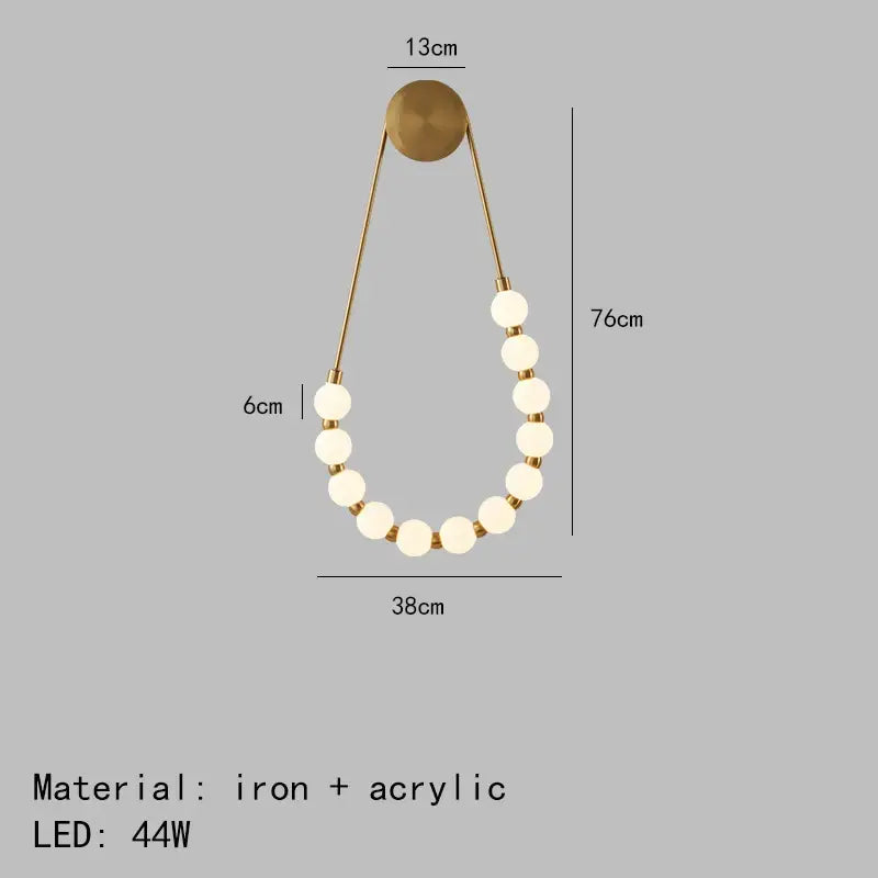 Gold-toned DecorBites LED necklace wall lights with black metal arms and white acrylic spheres for elegant home decor
