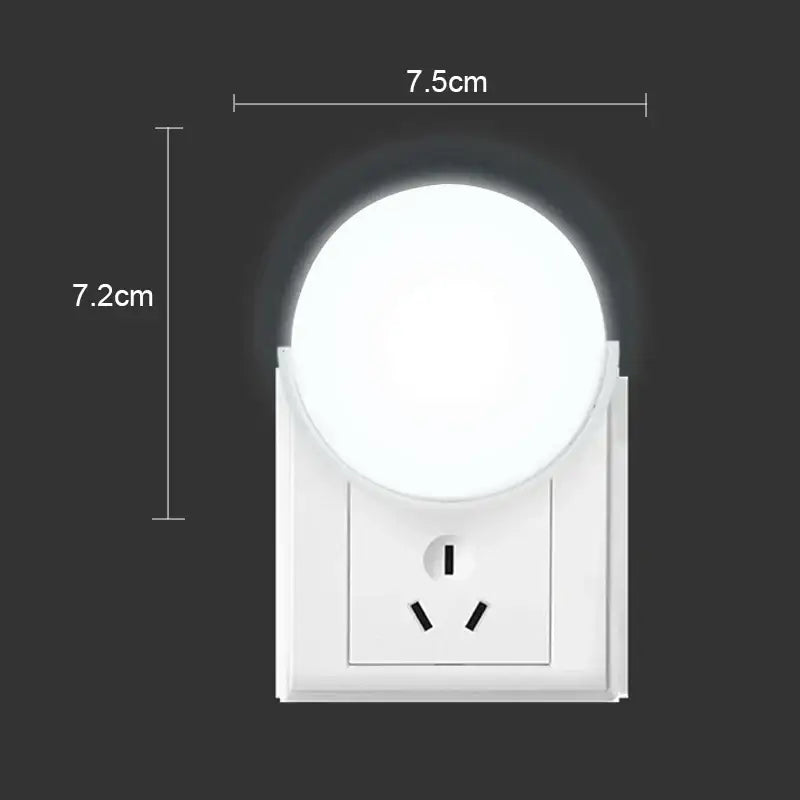White DecorBites™ LED night light with circular illuminated head and rectangular base featuring EU plug and outlet