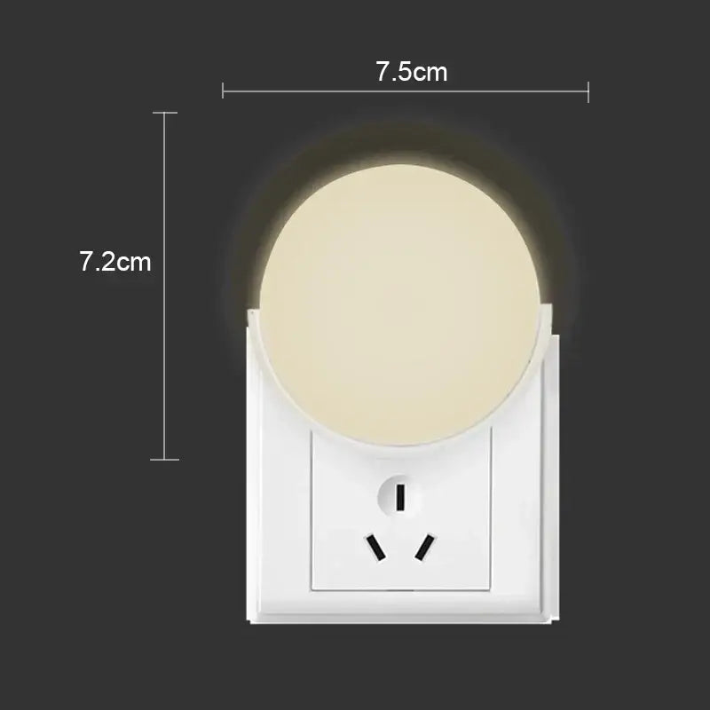 White plastic DecorBites™ LED night light with circular beige glow and integrated three-prong EU outlet for bedroom use