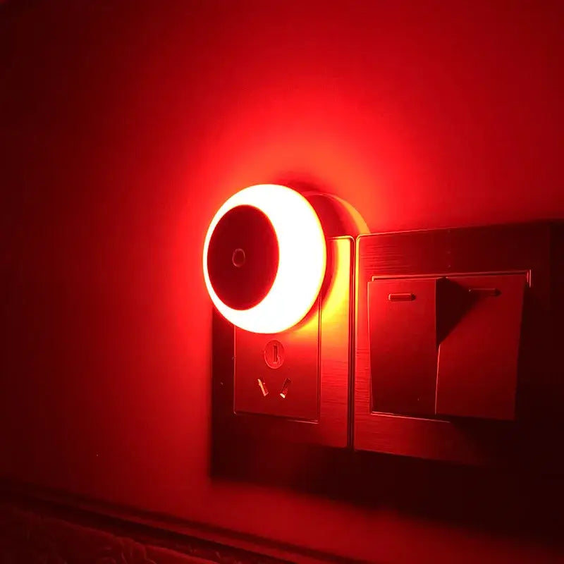A glowing warm white DecorBites led night light with smart sensor plug-in for home bedroom and hallway use