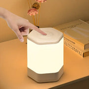 A sleek hexagonal decorbites led night light with soft white glow and human touch control for bedside table use