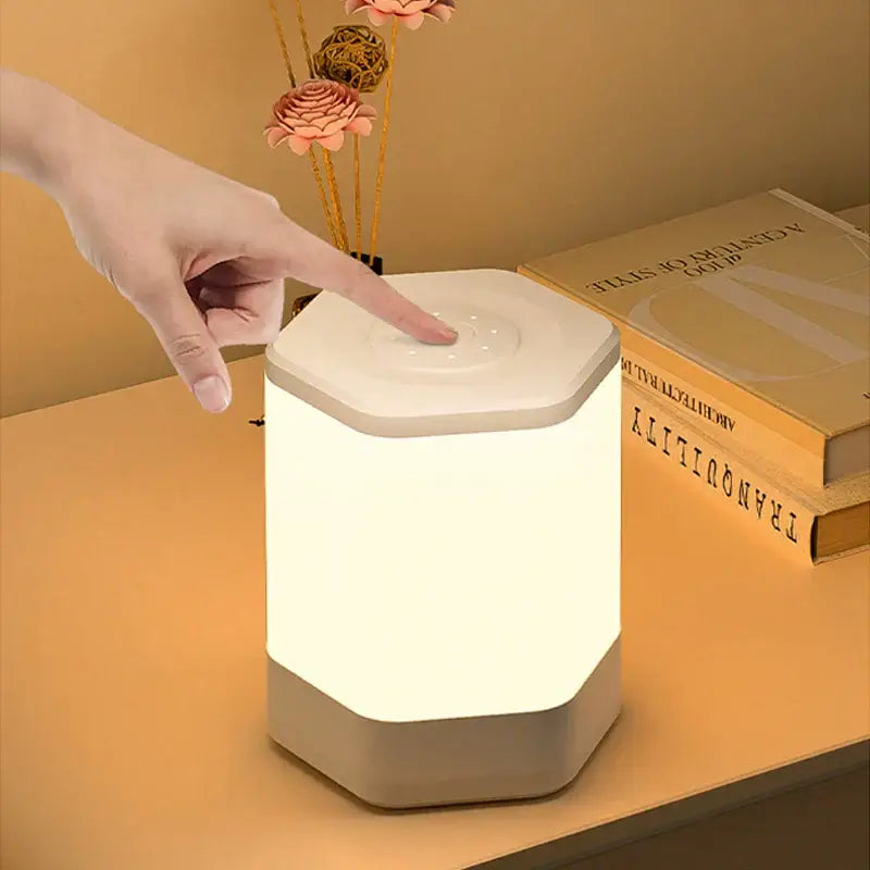 A sleek hexagonal decorbites led night light with soft white glow and human touch control for bedside table use