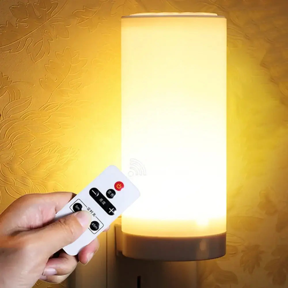 A warm yellow glow decorbites led night light with a sleek white remote control for bedroom bedside use