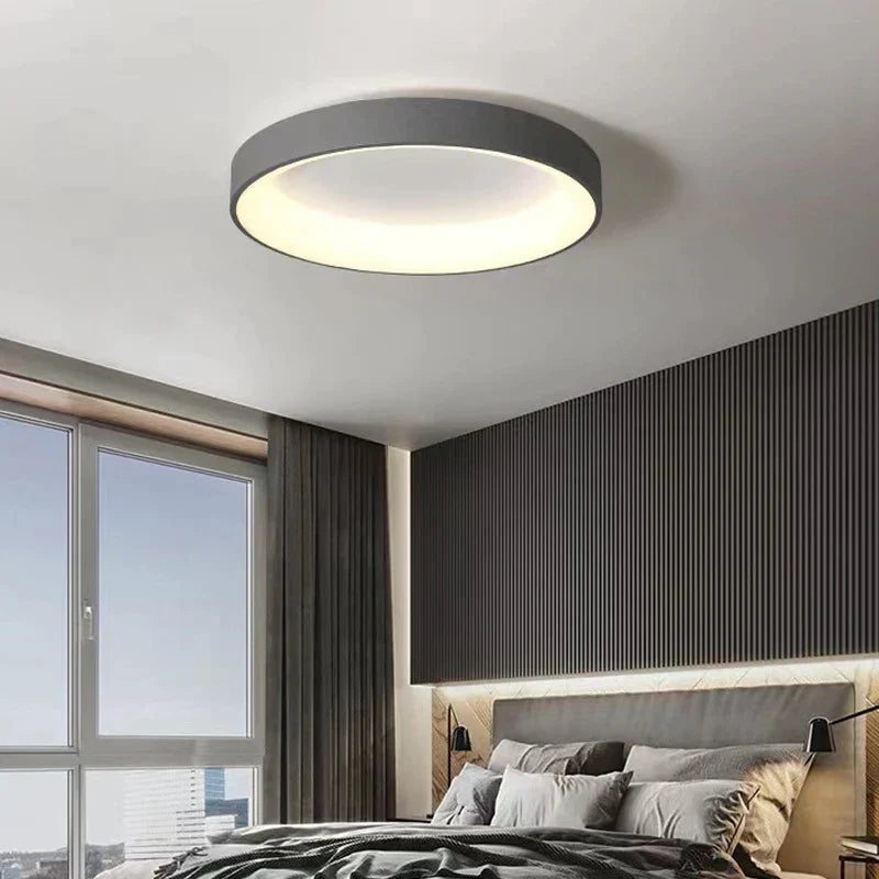 Modern black circular ceiling light with white interior, minimalist design.