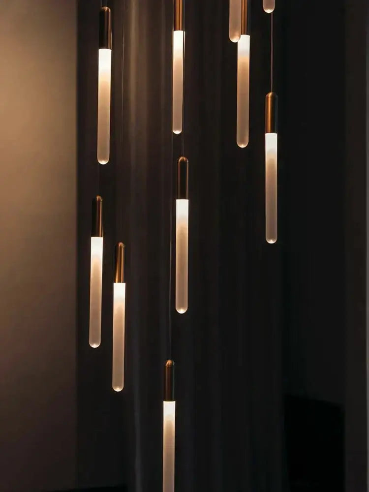Modern pendant lights with warm cylindrical glass shades and brass accents in decorbites led nordic cylinder chandelier design