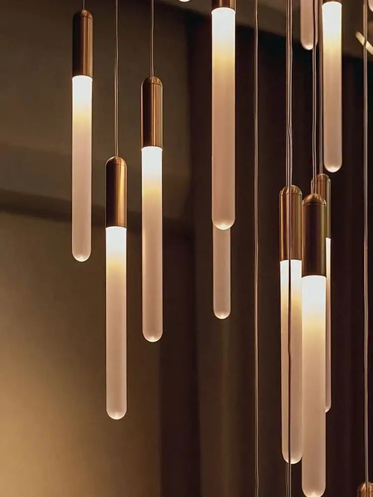 Modern decorbites led nordic cylinder chandelier with frosted glass tubes and brass caps emitting warm indoor lighting