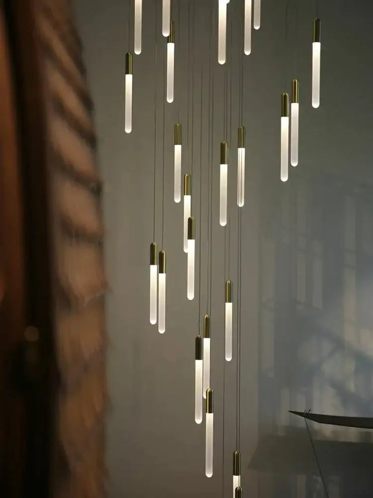 Modern pendant lights with frosted glass tubes and brass accents in a decorbites led nordic cylinder chandelier