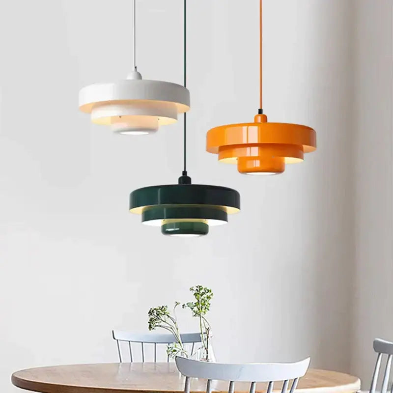 Three modern tiered pendant lights in white orange and green with metallic finishes from decorbites led nordic pendant series