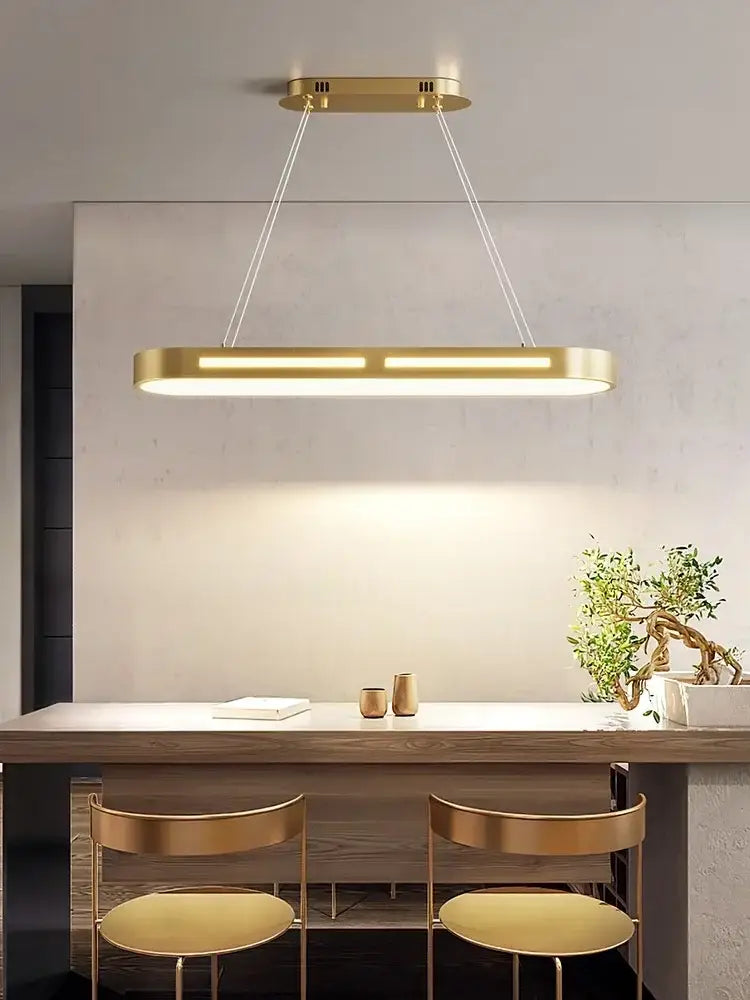 Gold-finished rectangular pendant light with sleek modern design by DecorBites led office chandelier above dining table