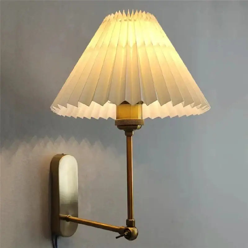 A cream-colored pleated paper lampshade mounted on a brass adjustable arm wall lamp decorbites led origami wall light