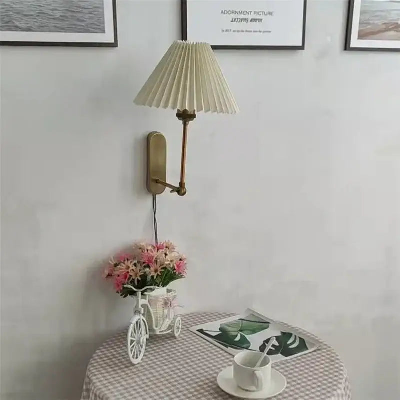 Beige pleated lampshade mounted on brass wall sconce in decorbites led origami wall lamp for bedroom and living room