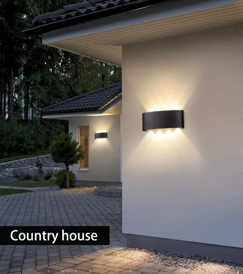 Modern black DecorBites LED outdoor wall light with three warm-toned LED outdoor garden lights wall-mounted fixture