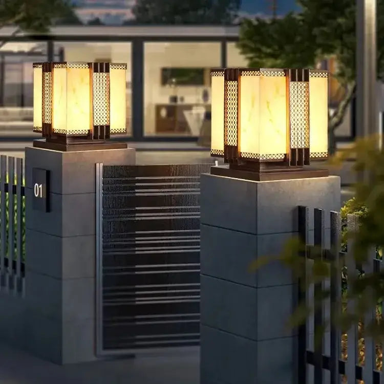 Warm-toned decorbites led outdoor marble street lamp with amber glass lattice panels on stone pillars for fence lighting