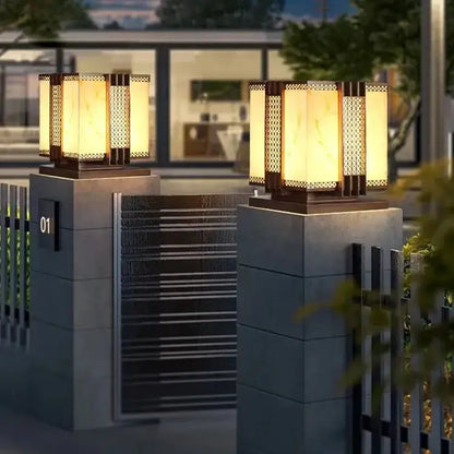 Warm-toned decorbites led outdoor marble street lamp with amber glass lattice panels on stone pillars for fence lighting