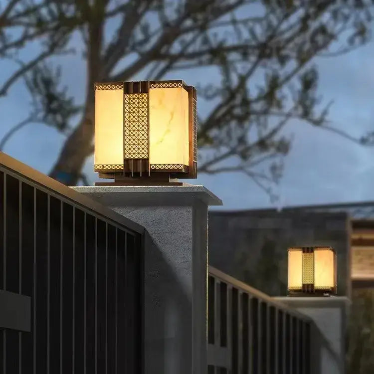 Warm-toned decorbites led outdoor street lamp with golden metal frame and intricate lattice for pillar fence lighting