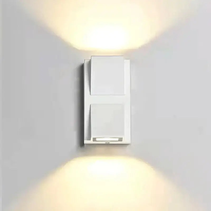 White rectangular wall light with two angled fixtures emitting warm light from decorbites led outdoor porch lamp