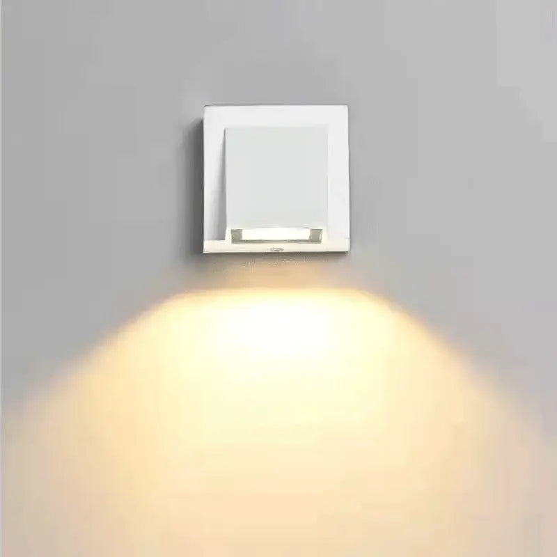 Modern white square decorbites led outdoor wall light with sleek minimalist design emitting warm light for porch use