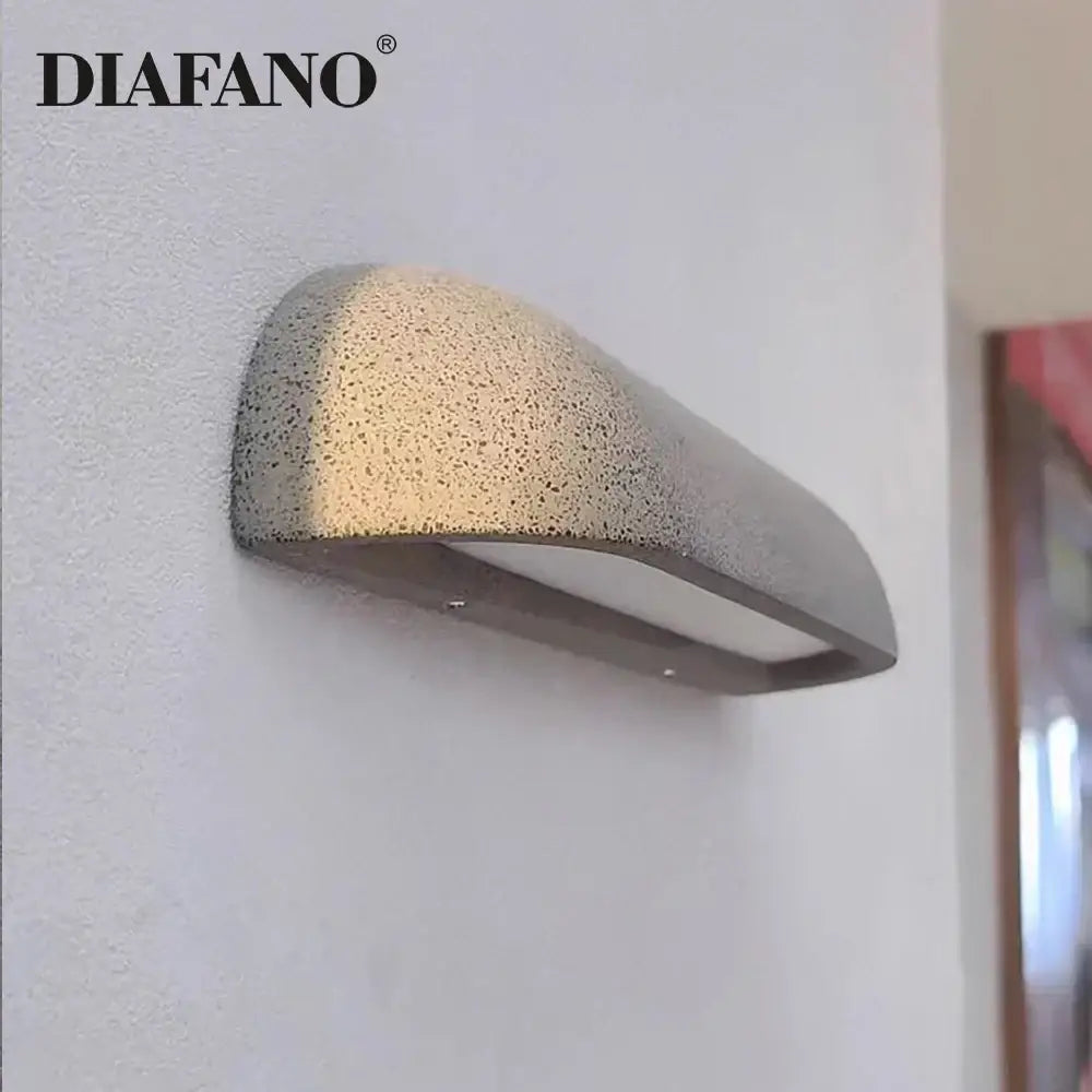 Diafano decorbites led outdoor wall lamp with textured speckled gray concrete finish and sleek metallic base for outdoor use